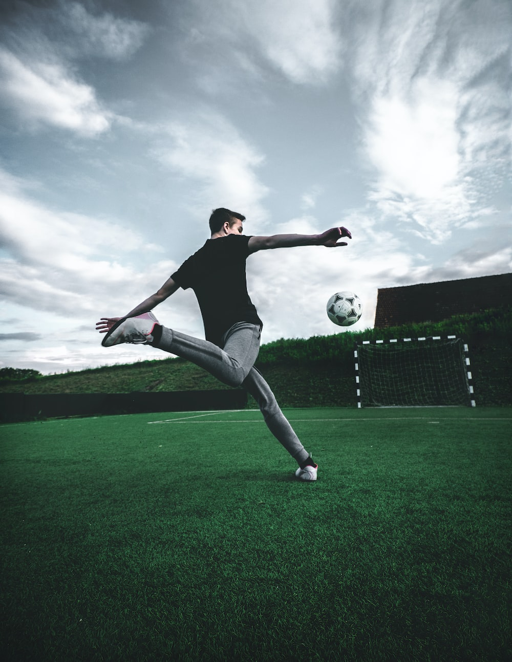 a soccer player attempting to score a volley goal during training session 