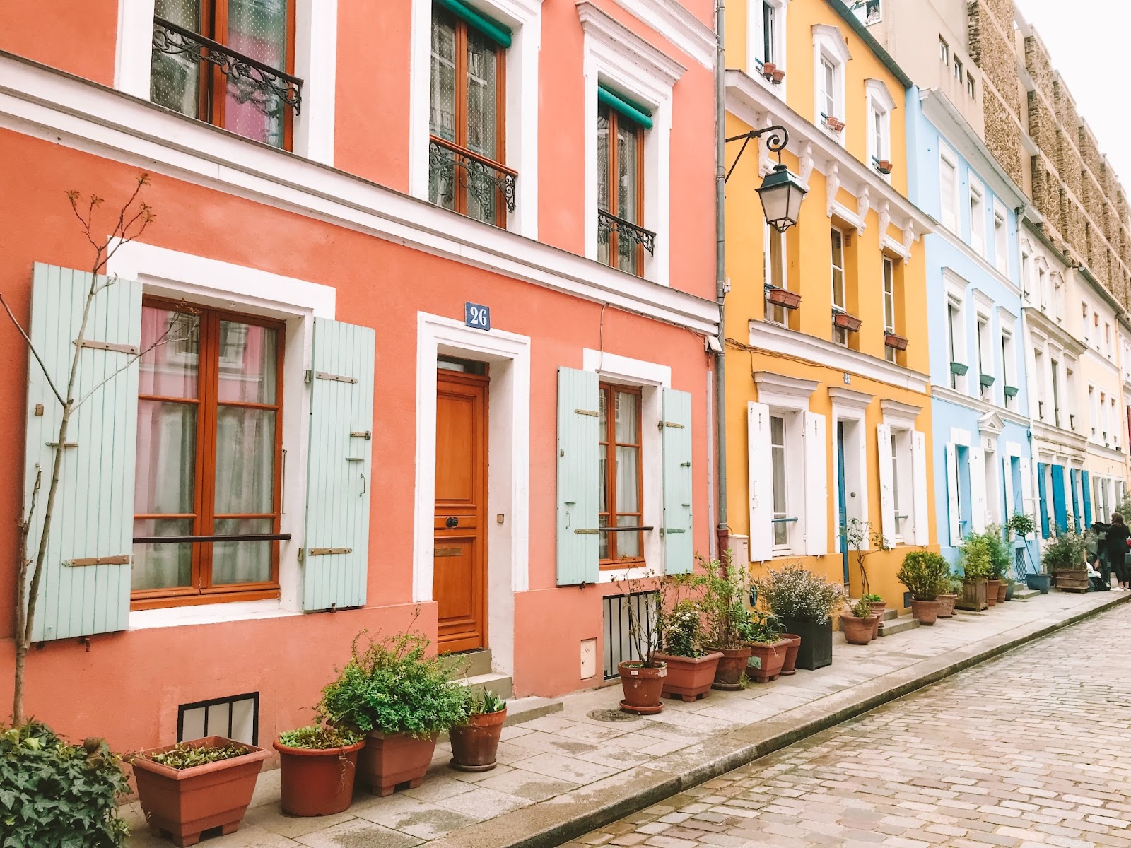 Colorful houses outline cobblestone streets in Rue Cremieux.