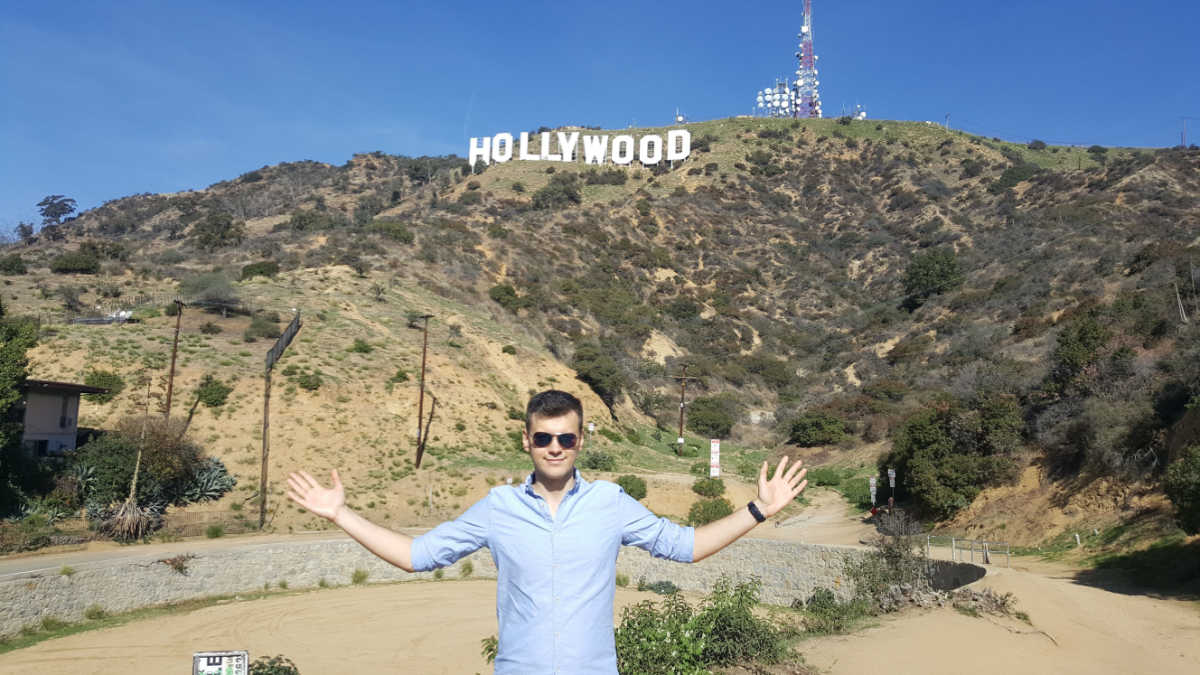 Male tourist in front of Hollywood sign
