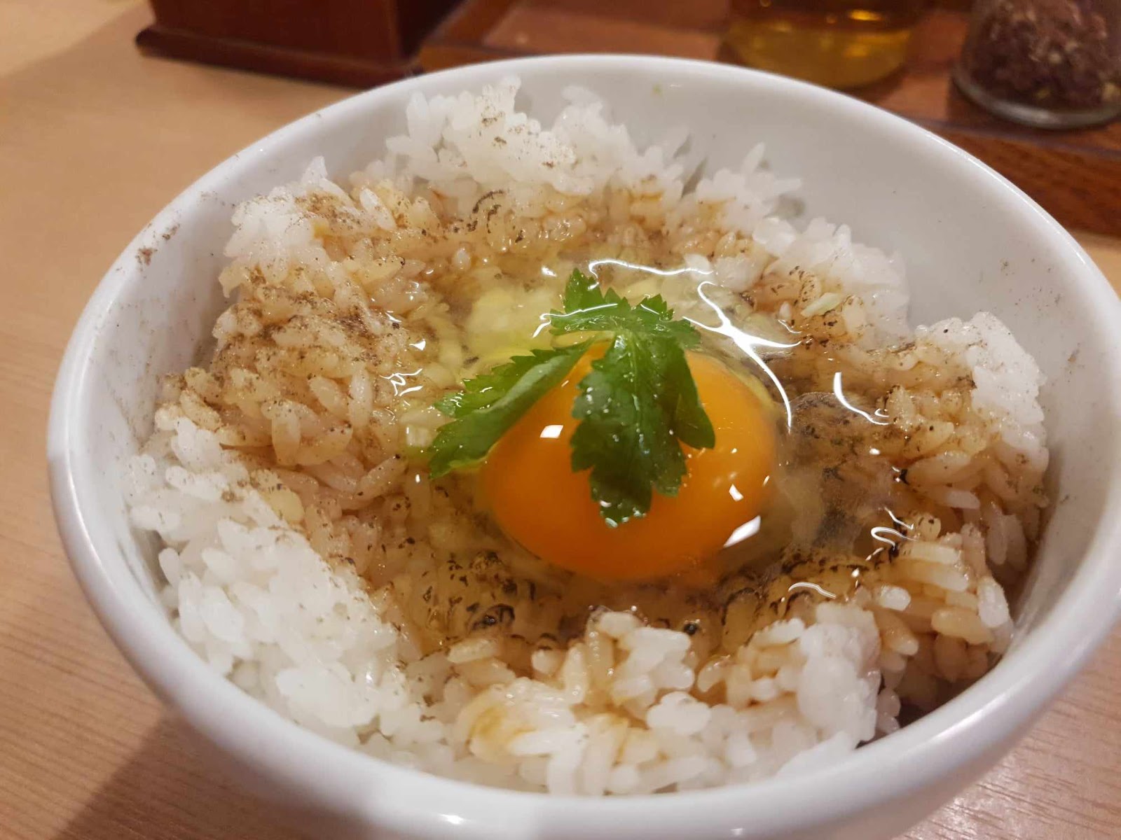 TKG rice bowl with raw egg over bed of rice and soy sauce