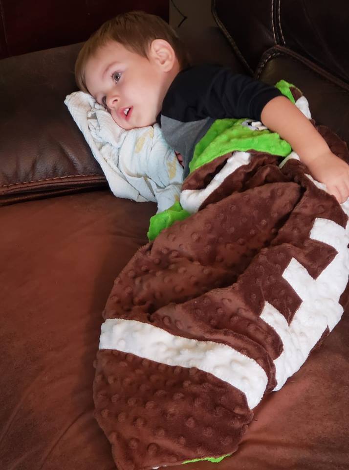 Our little football buddy cuddled in his blanket watching the game. 