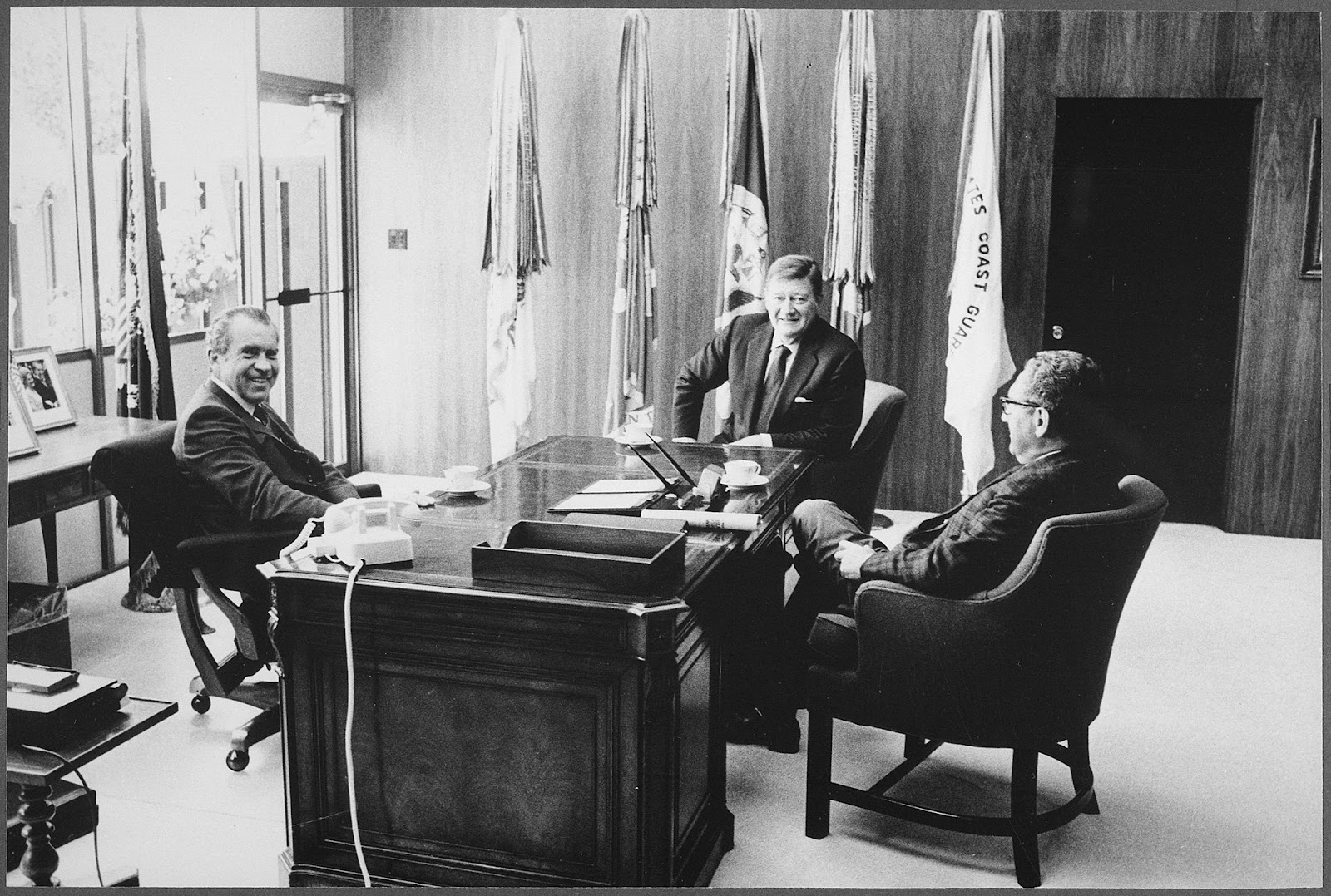 A photograph of Wayne sitting with President Nixon and Henry Kissinger