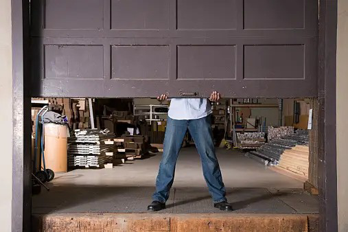 A man opening a garage door