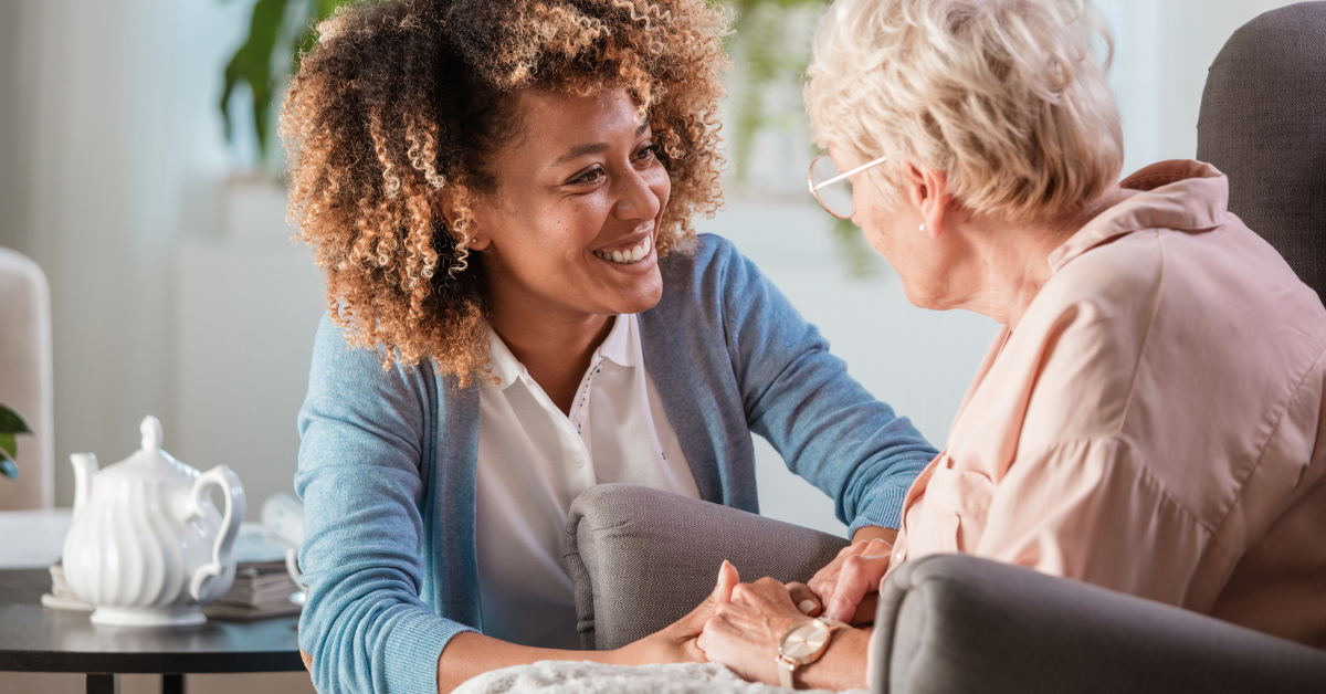 Supportive Caregivers: A young woman holding hands with an elderly woman. Caregivers and family members.