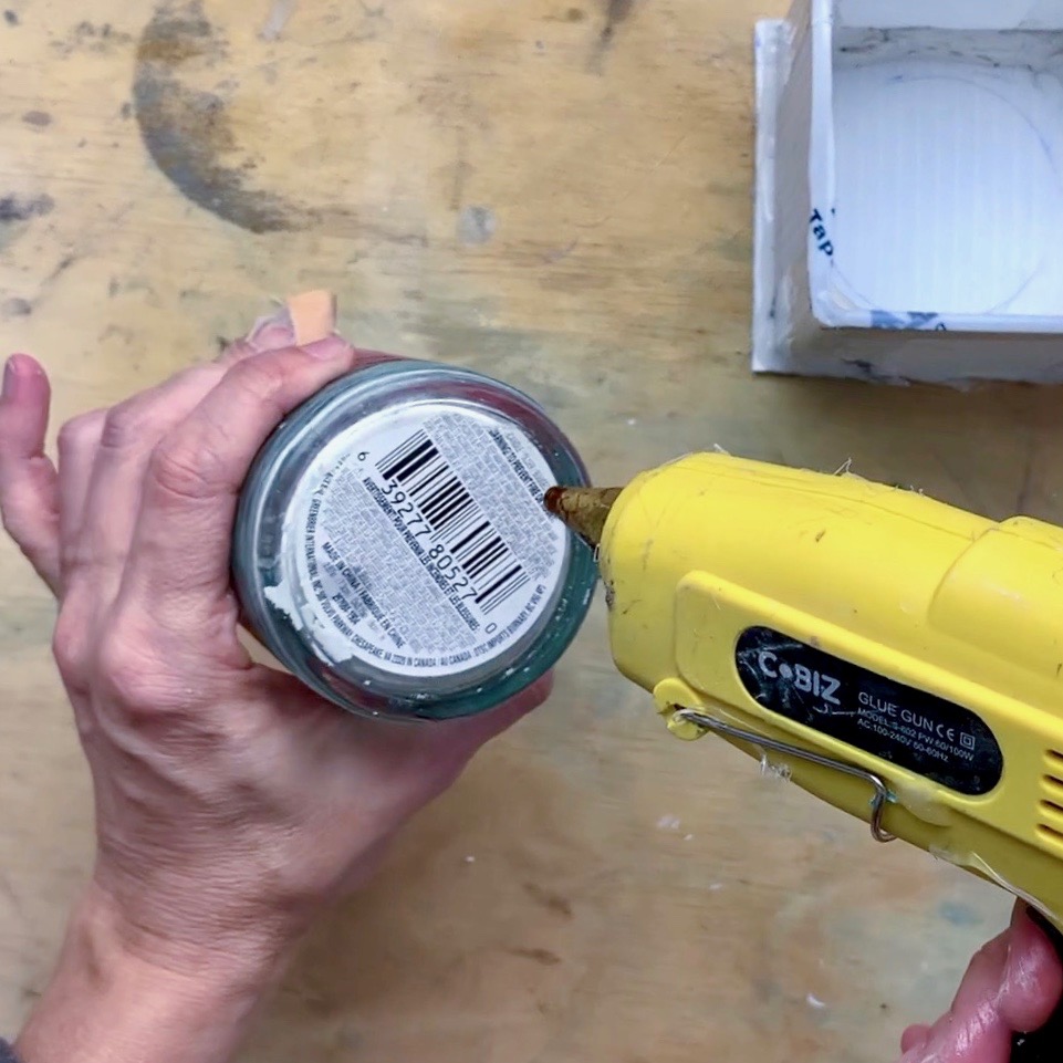 using hot glue to glue bottom to plastic base