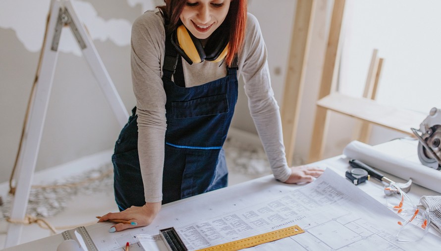 Woman looking over construction plans