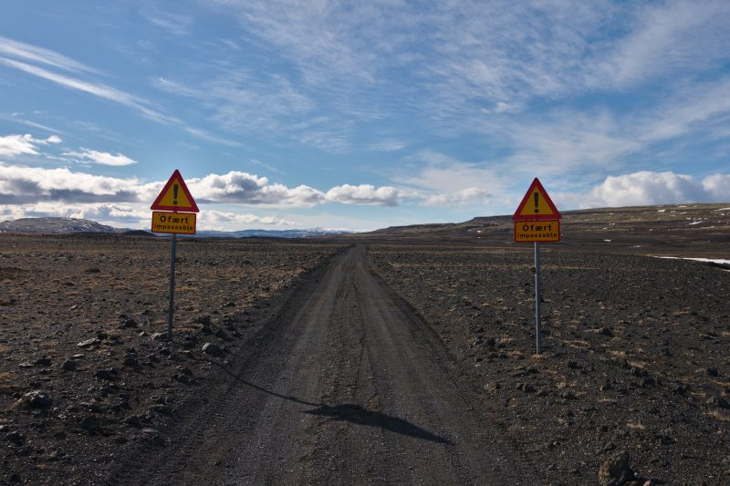 Dirt road with the warning signs saying Impassable. 