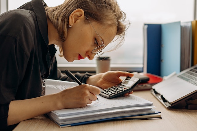 a girl calculating numbers and keeping track in the books