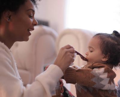 Mother feeding toddler