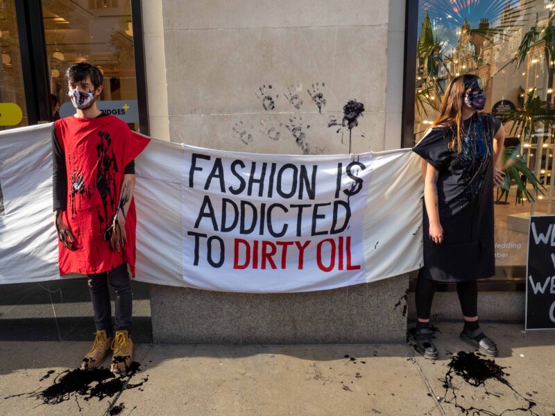 XR Fashion Action blocking the entrance of Selfridge with a banner "Fashion is addicted to dirty oil"