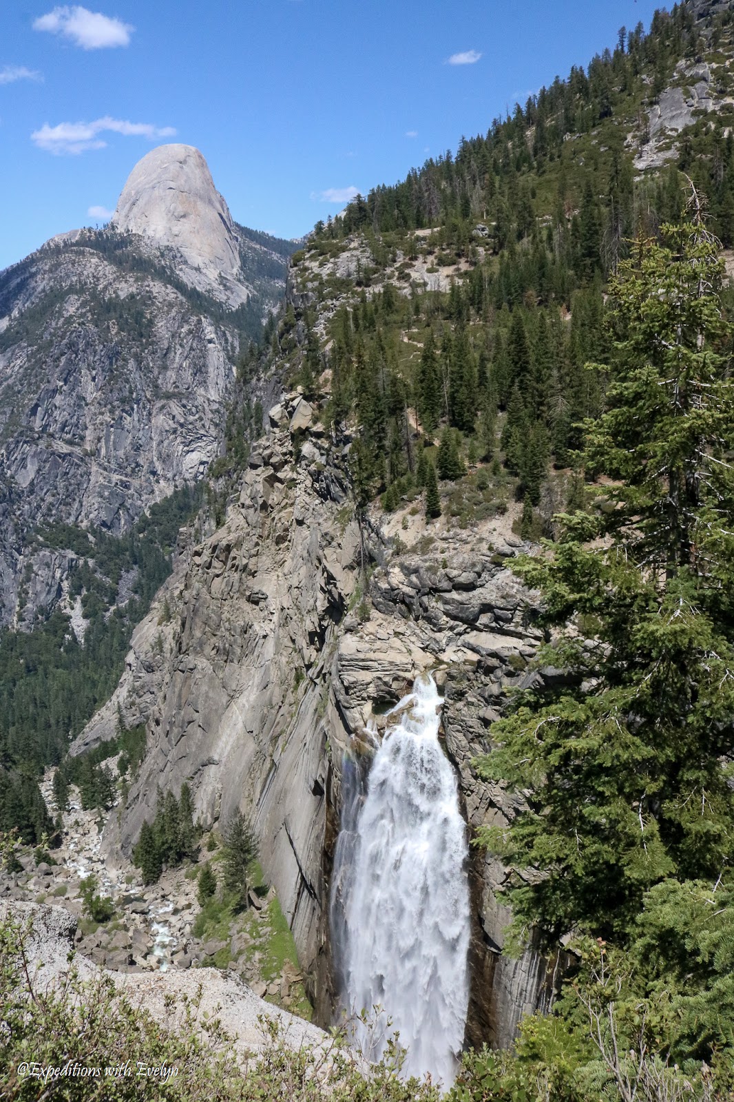 Illilouette Fall cascades down a cliff with the back of Half Dome in the background
