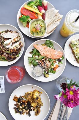 A dinner spread with salmon, salads and vegetables