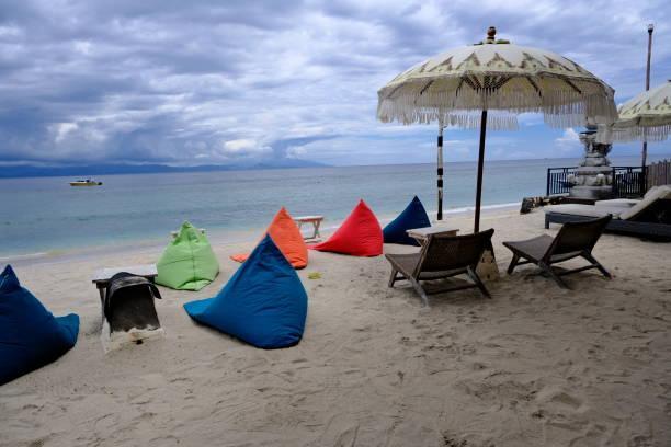 Colorful bean bags on the beach bar in Bali, Indonesia Private beach bar with bean bags on the beach in Bali, Indonesia outdoor beanbags stock pictures, royalty-free photos & images
