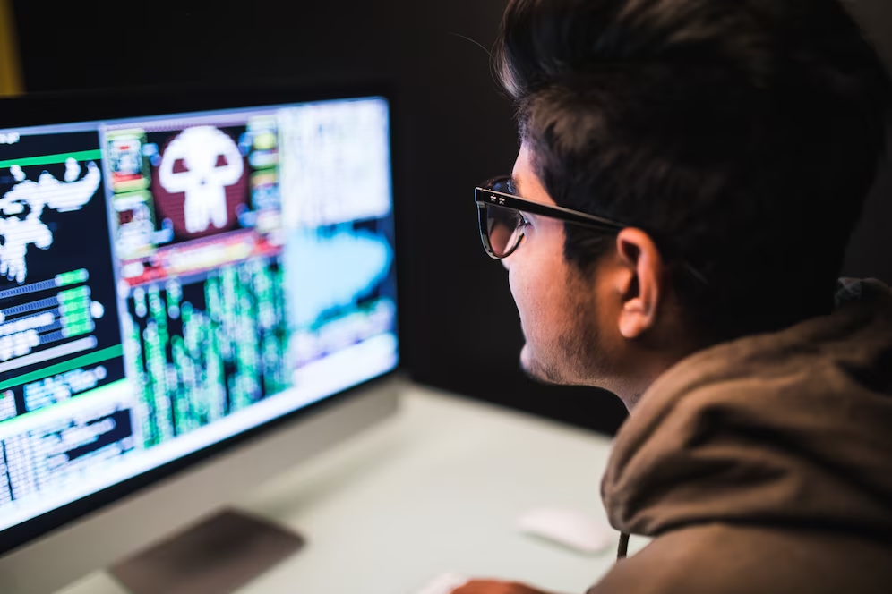 Man working on his laptop, creating a game