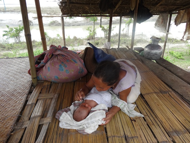 Mohini Pait delivered her daughter on the day after floods in the Rekhasapori village of Assam state washed her house away. She and her baby are currently living in one of many relief camps that dot the roads in flood-affected areas throughout Assam. Credit: Priyanka Borpujari/IPS