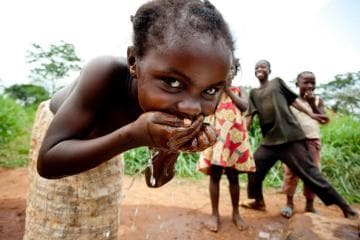 Child Smiling while Drinking Water