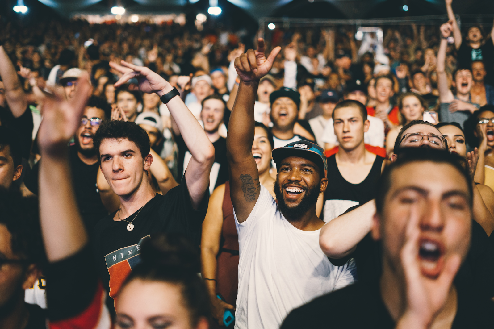 A crowd of people at a rap concert.