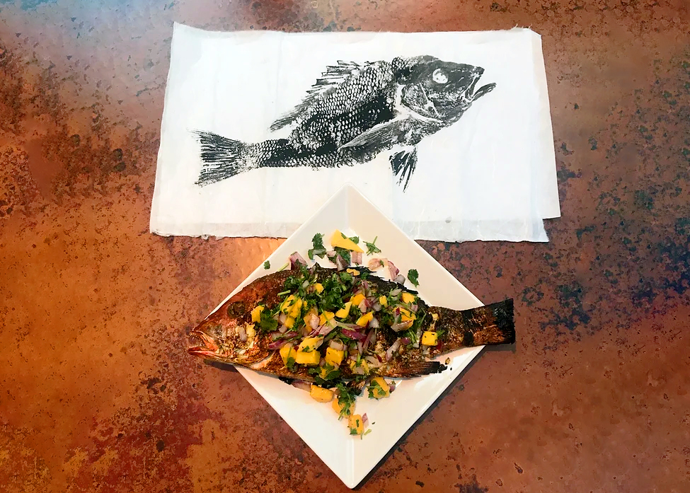 Before and After Red Snapper, Gyotaku print on top, cooked red snapper on plate below