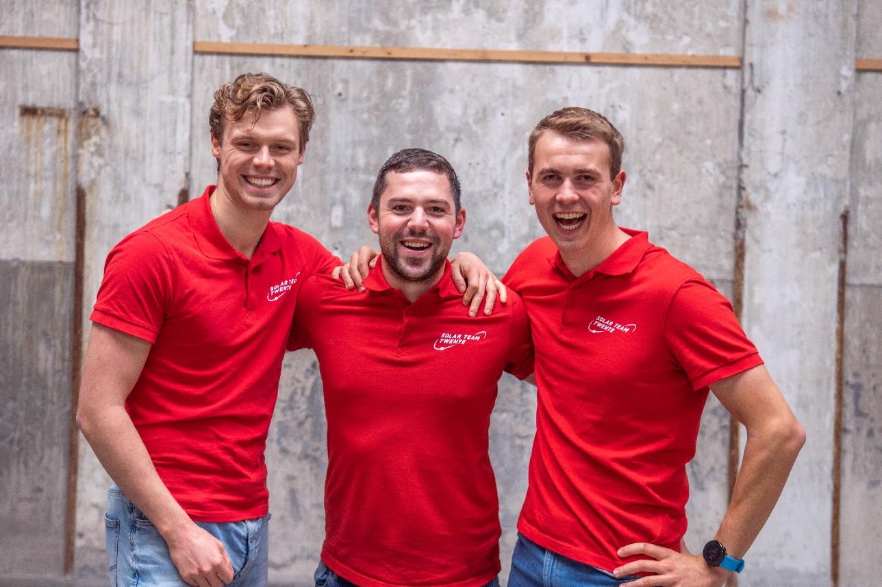 A group of men in red shirts

Description automatically generated