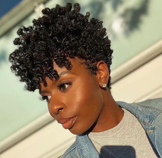 Beautiful woman wearing finger coils for styling her natural short hair