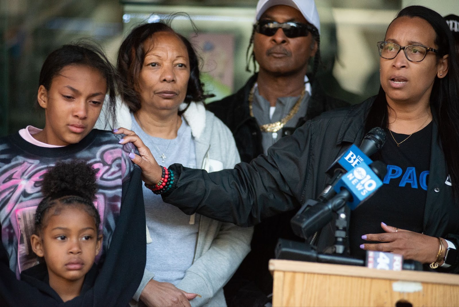 Leia Schenk, far right, and the parents and children of shooting victim Sergio Harris.