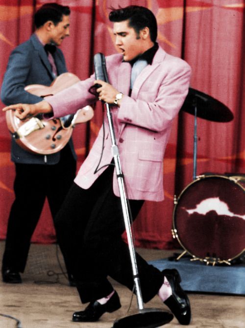 elvis wearing pink blazer singing performing on stage