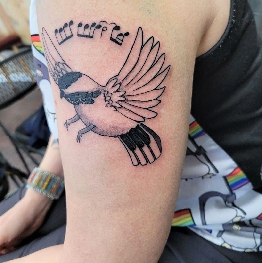 Beautiful Bird Creating Music Tattoo