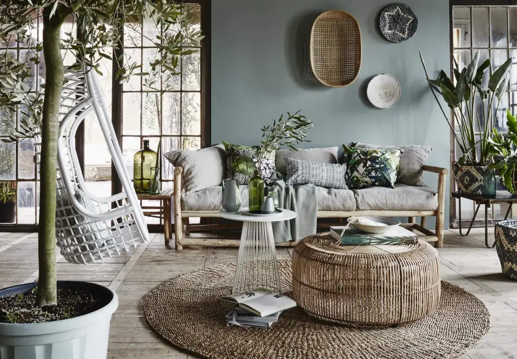 Living room looking and feeling very tropical with plants, natural textures and forest hues