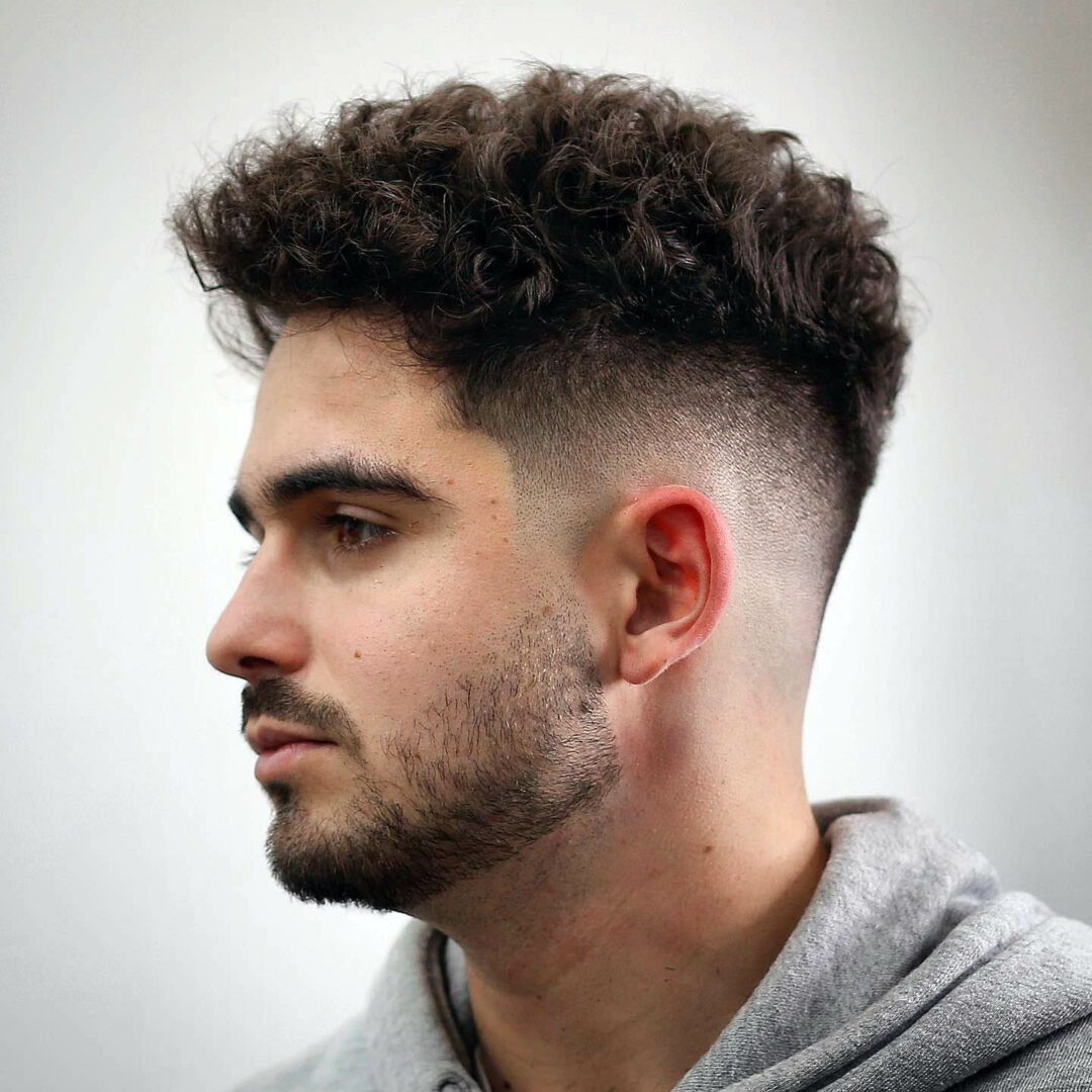 a man wearing curly hairstyles for men
