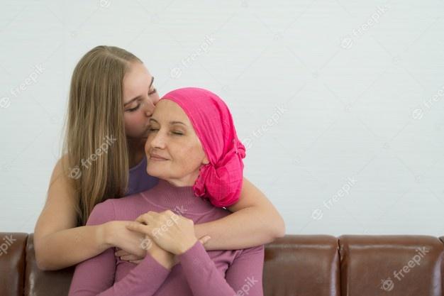 Paciente de cáncer de sexo femenino joven que pasa tiempo con su hija en casa. Foto Premium 