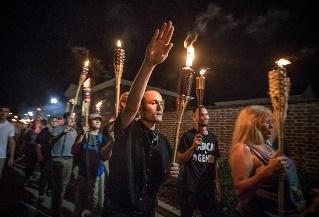 A person holding a torch in front of a crowd of people

Description automatically generated with low confidence