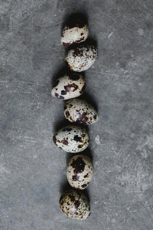 Raw quail eggs scattered on table