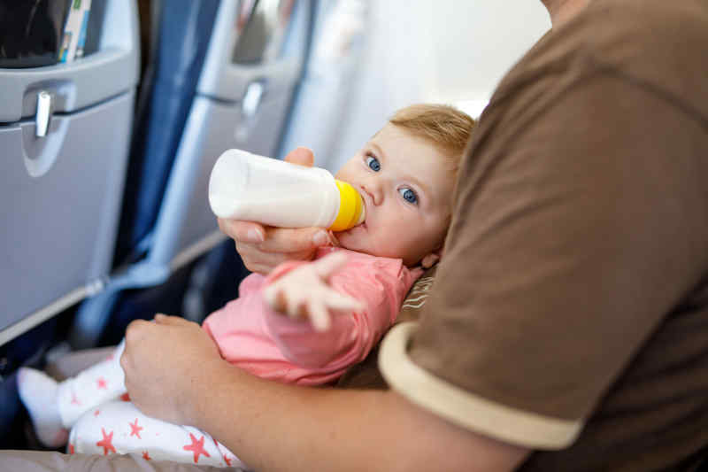 baby on lap with bottle