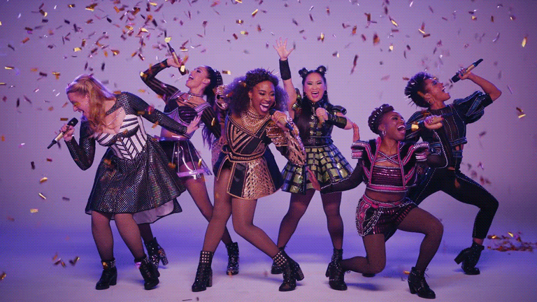 The Broadway cast of six posing with confetti falling.