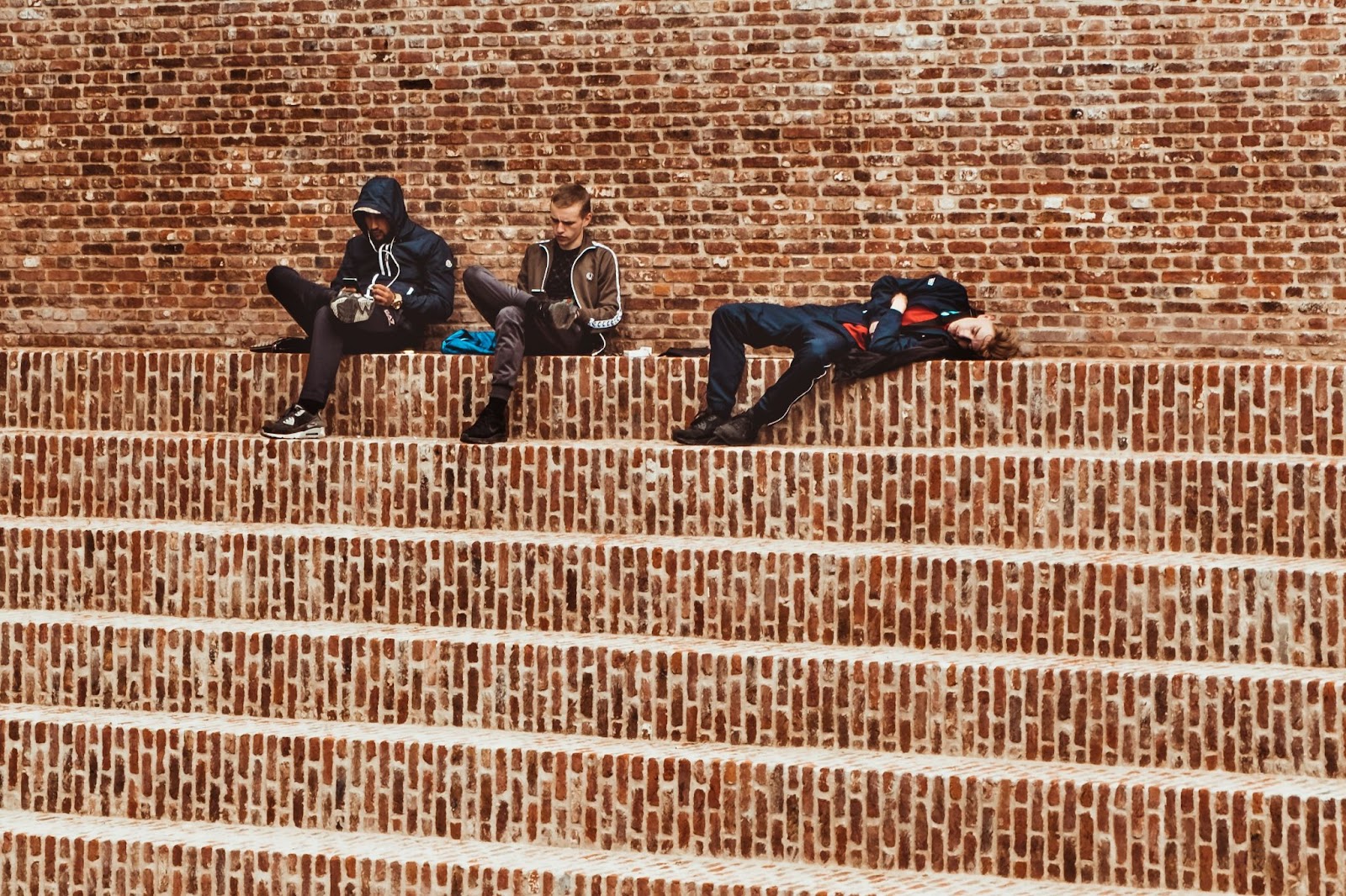 Kids laying on the building