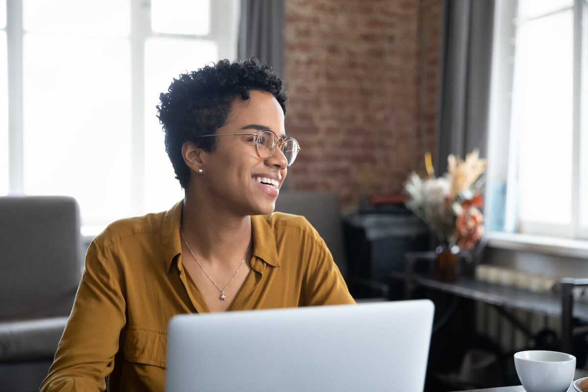 Patient smiling and using a laptop