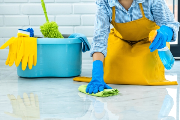 wife-housekeeping-cleaning-concept-happy-young-woman-blue-rubber-gloves-wiping-dust-using-spray-duster-while-cleaning-floor-home