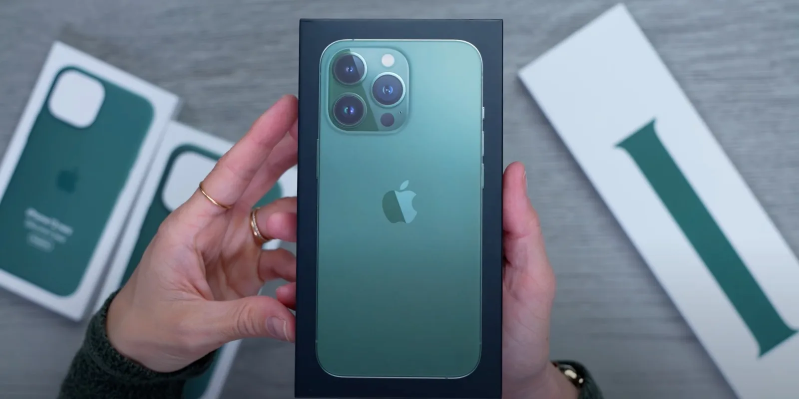 This image shows the iPhone 13 Pro box pack in the hands of man.