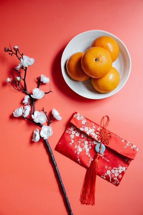 Chinese new year - lucky tangerines, red envelope, and cherry blossom