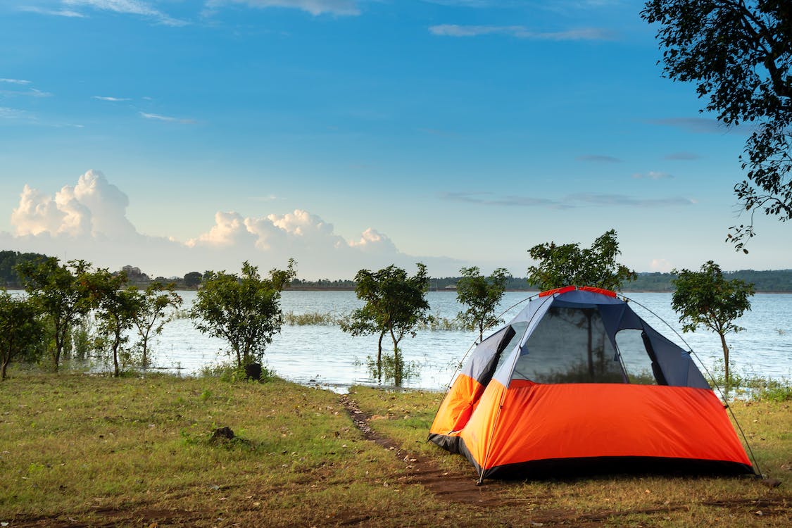 Free Camping  Dome Tent Near a Body of Water Stock Photo