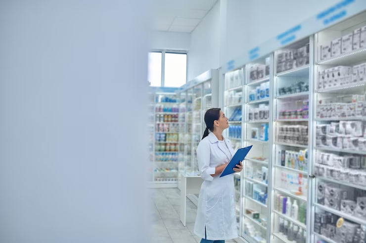Dedicated pharmacist carefully checking medicines in a drugstore, focused on ensuring safety and accuracy.