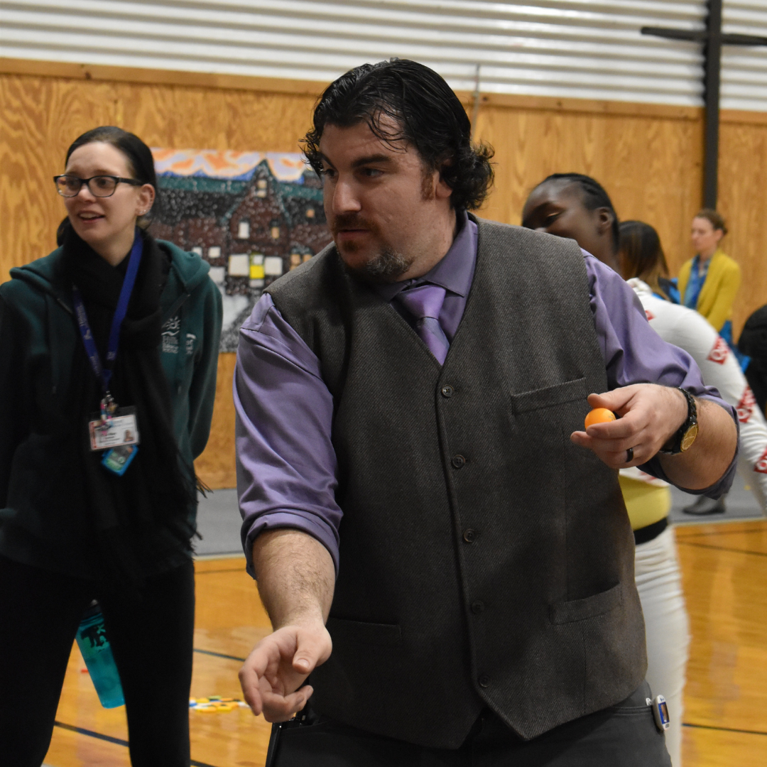 Mr. Quinlan playing a carnival game a student created at the science and art fair at Brookside. 