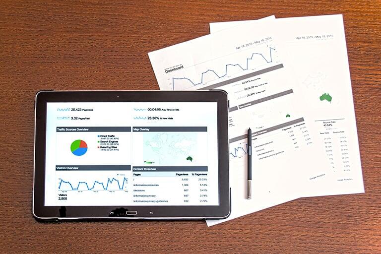 A tablet with charts and diagrams analyzing traffic and marketing.