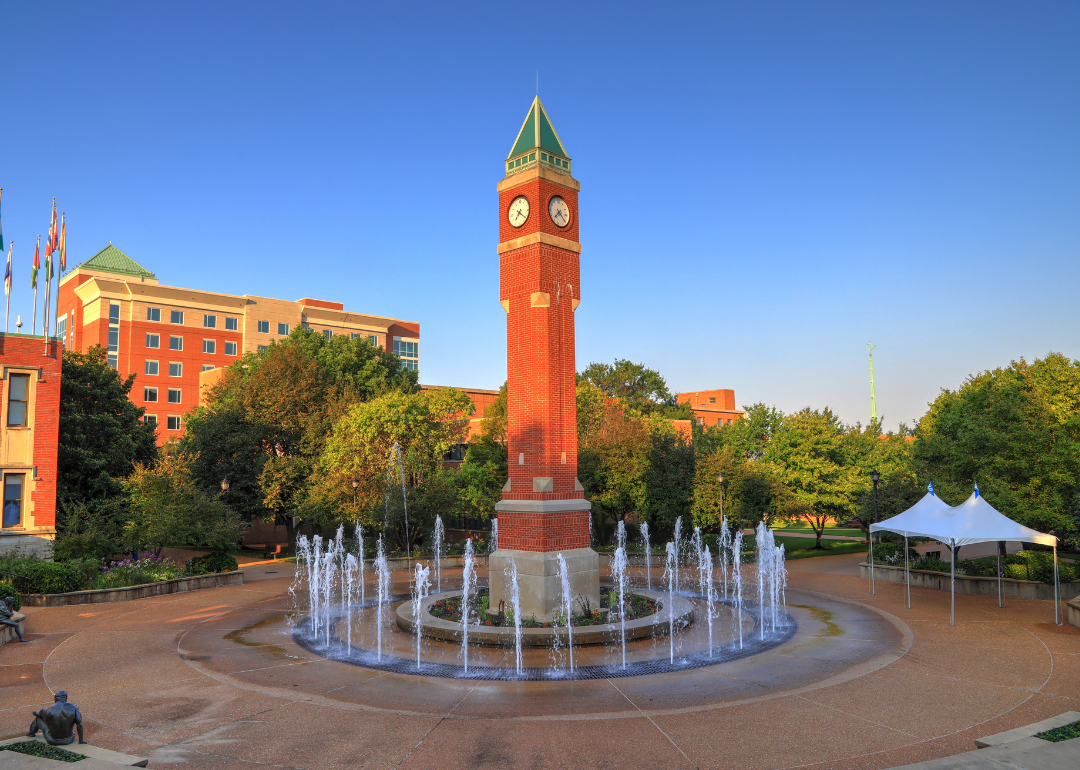 A  clock tower and fountain at Saint Louis University.