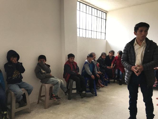 A group of people sitting in a room

Description automatically generated with medium confidence