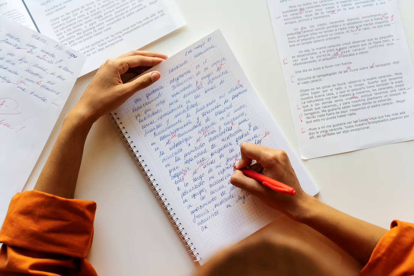 A person writing an essay on a paper