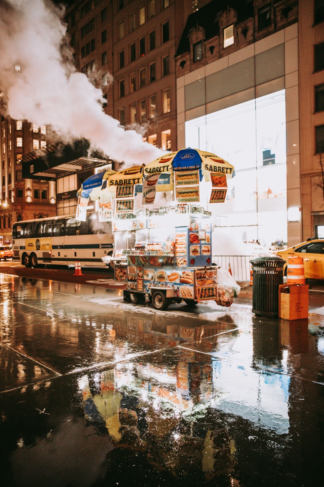  A hot dog stand open for business on a busy street.