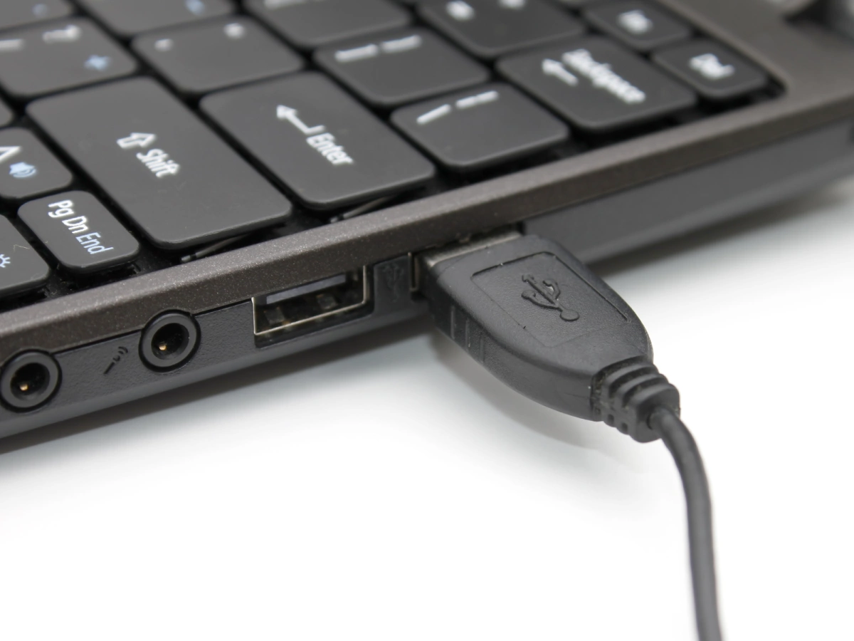 Insert the USB connector of the gaming keyboard cable into a USB port of your laptop.