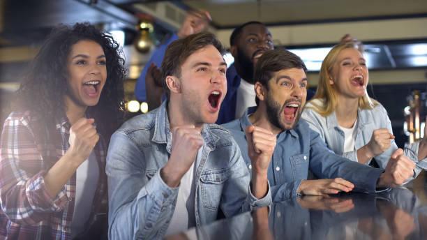 https://media.istockphoto.com/photos/group-of-fans-enjoying-sport-game-extremely-happy-about-win-relaxing-picture-id1158250621?k=20&m=1158250621&s=612x612&w=0&h=iFVxP3EHlp4yoFHRf7aPq5YxyMFIZ1AB67tRpkCHgNo=