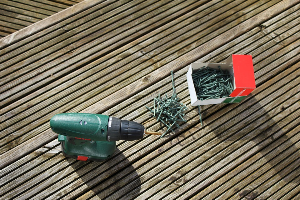 50+ screws with an automatic drill on a wooden deck.